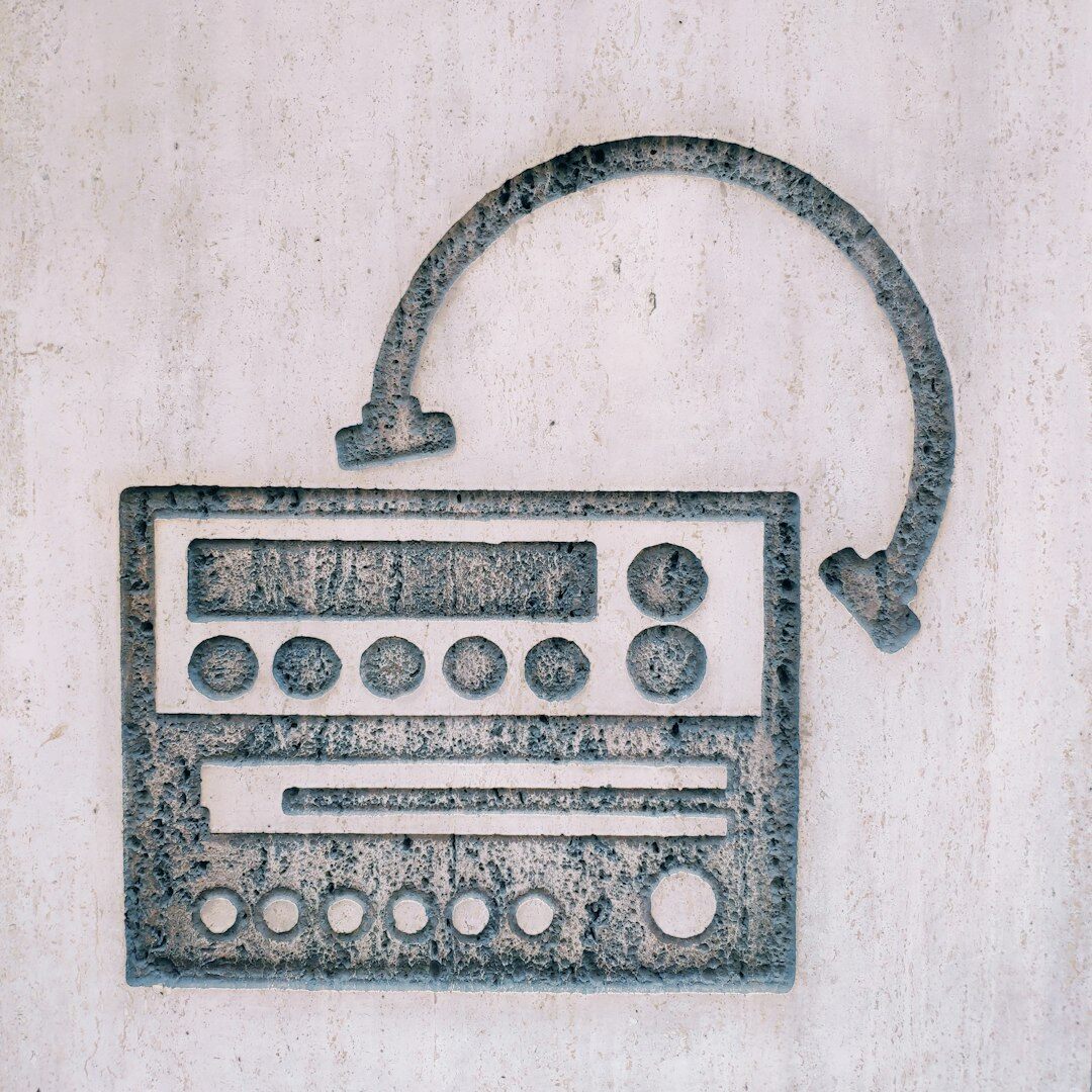 Radio presenter hosting a live show at a broadcast desk